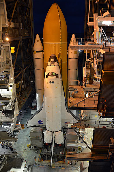 Final shuttle rolls out to launch pad as next-to-last lands